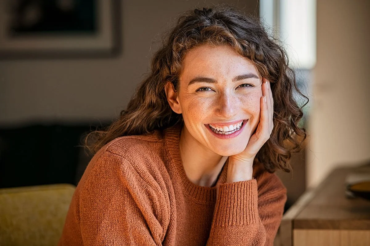 Woman smiles showing white teeth