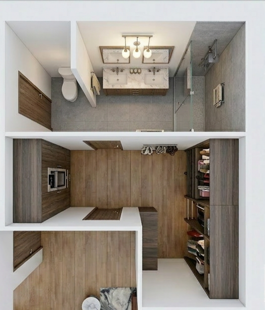 An overhead view of a small apartment layout with a bathroom, living area, and kitchen. The bathroom has a vanity, mirror, toilet, and shower. The kitchen features a microwave and countertop. The living area has a closet or shelves for clothes and sh