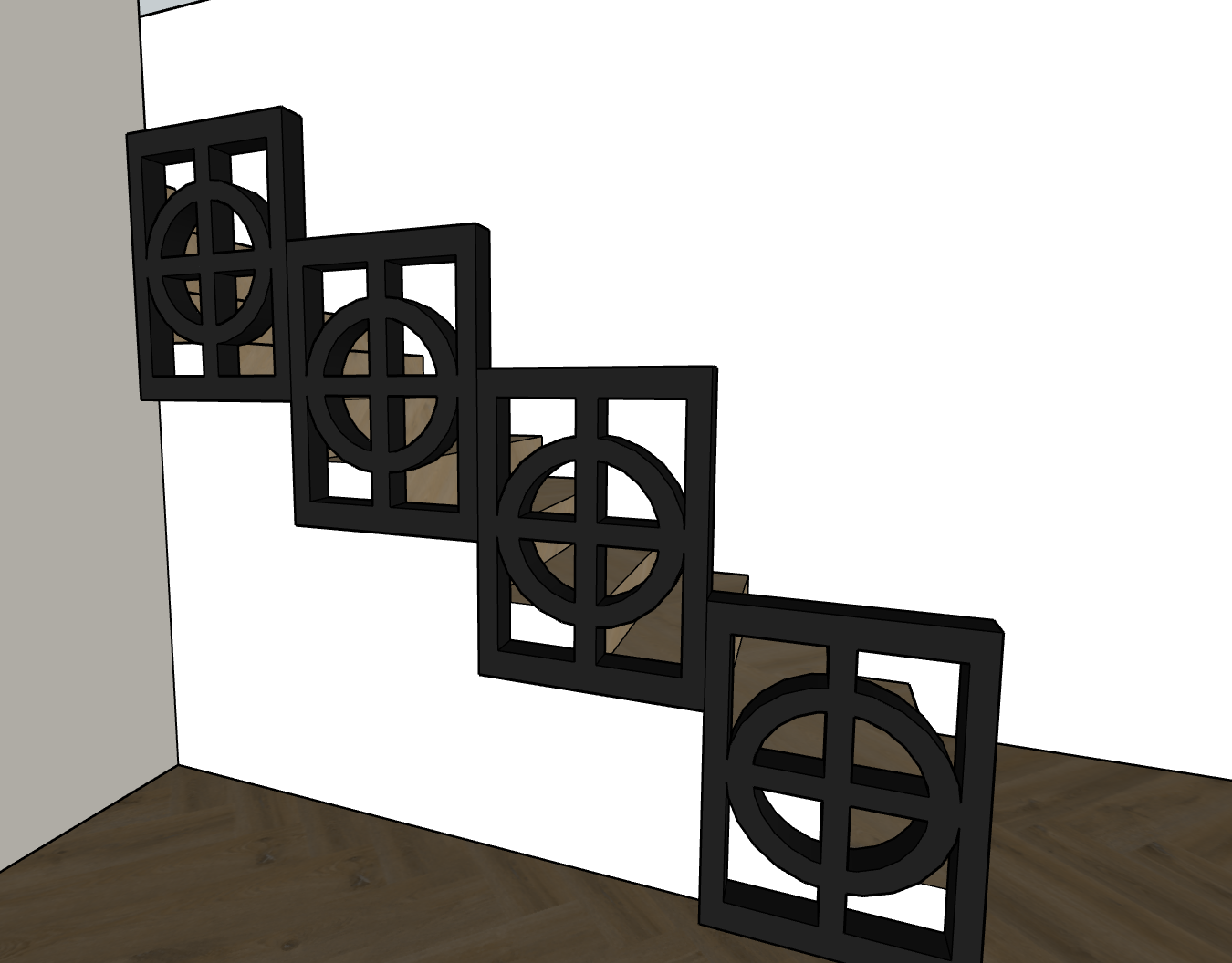 A staircase with black decorative railings featuring geometric circular and square patterns, ascending along a white wall in a room with wooden flooring.