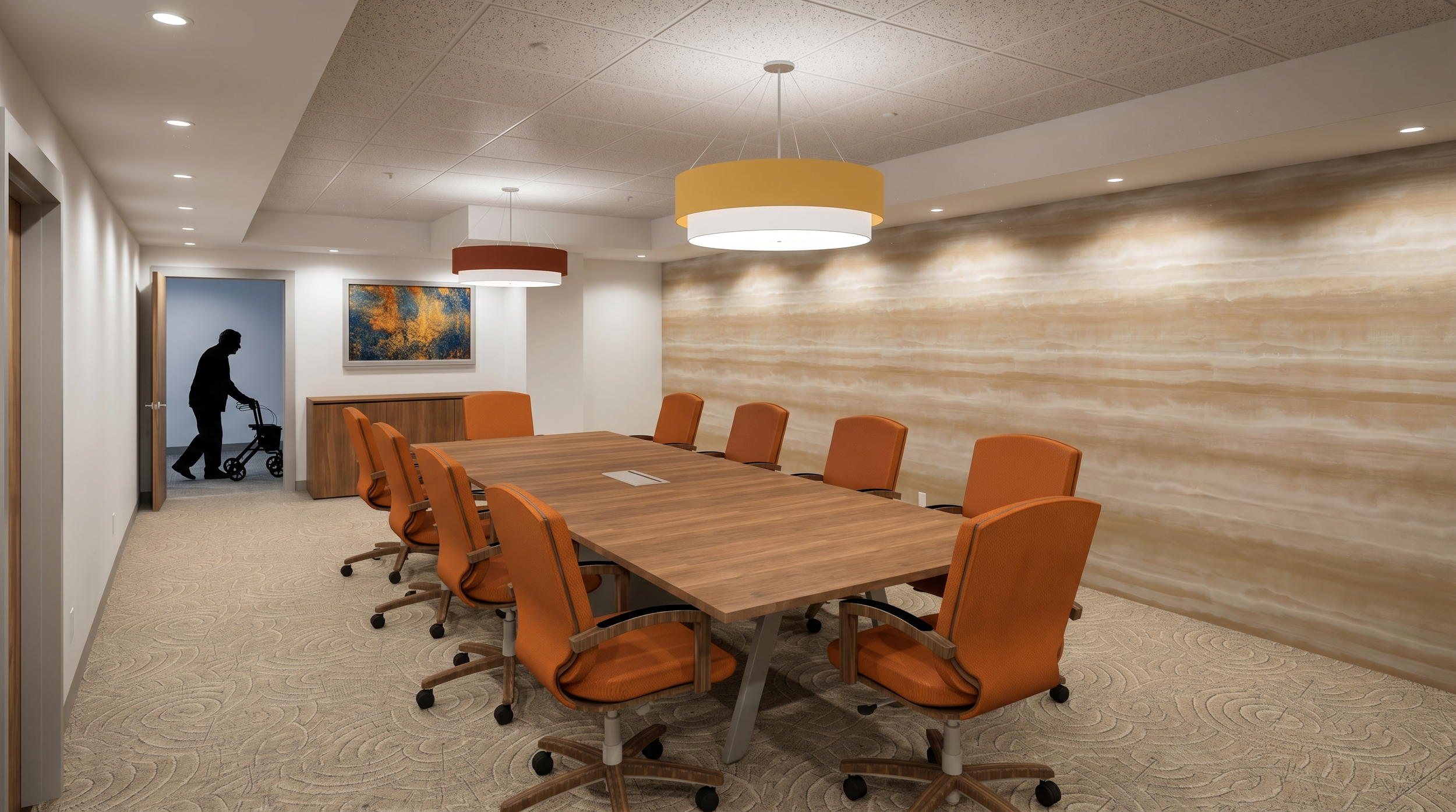 A contemporary conference room with a long wooden table surrounded by orange office chairs, beige carpet, and a large abstract painting on the wall. The ceiling has recessed lighting and modern hanging fixtures. A silhouetted person is walking with a