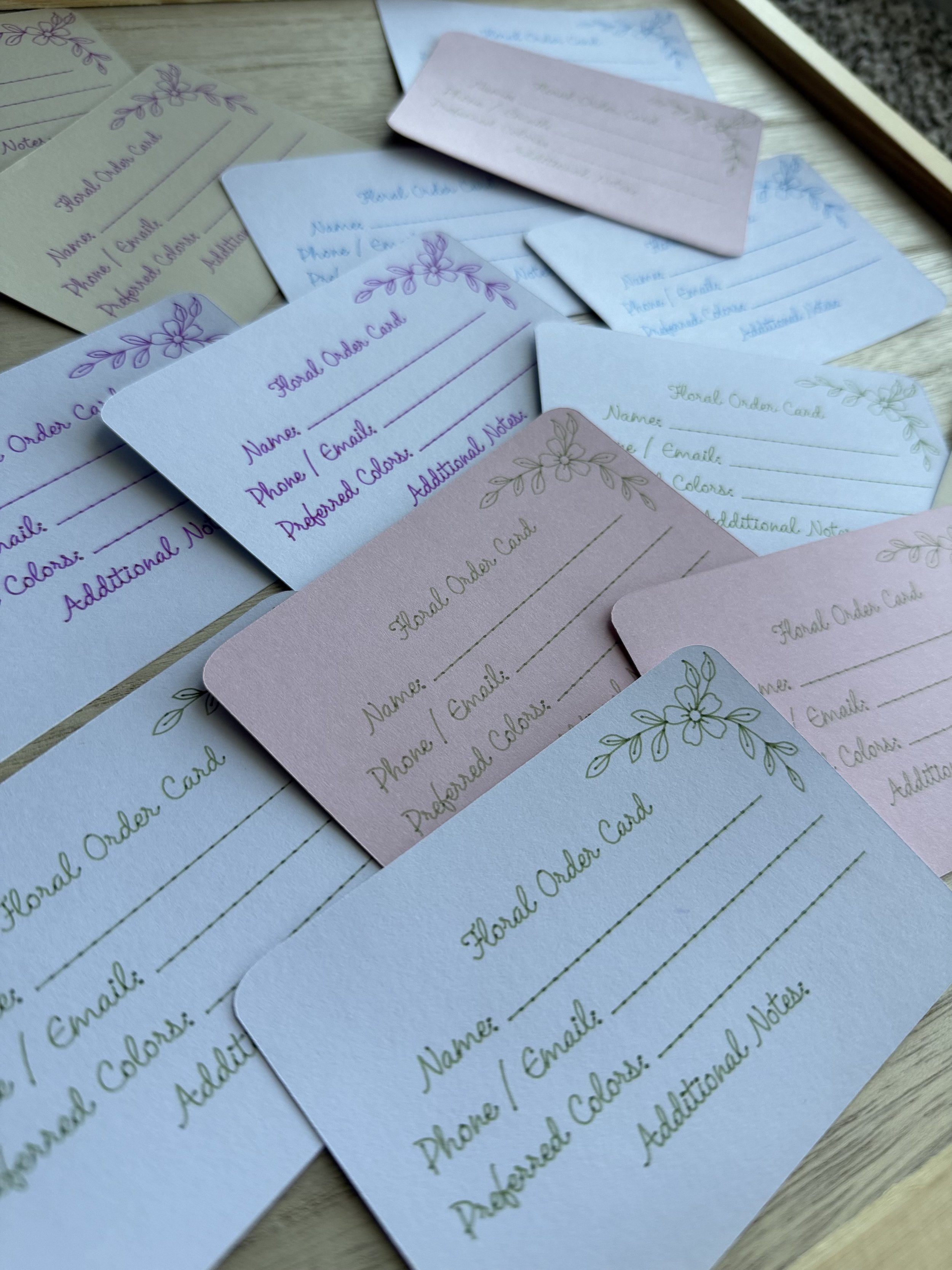A tidy assortment of handwritten cards and envelopes displayed in baskets and frames, emphasizing your handmade, minimalist style.