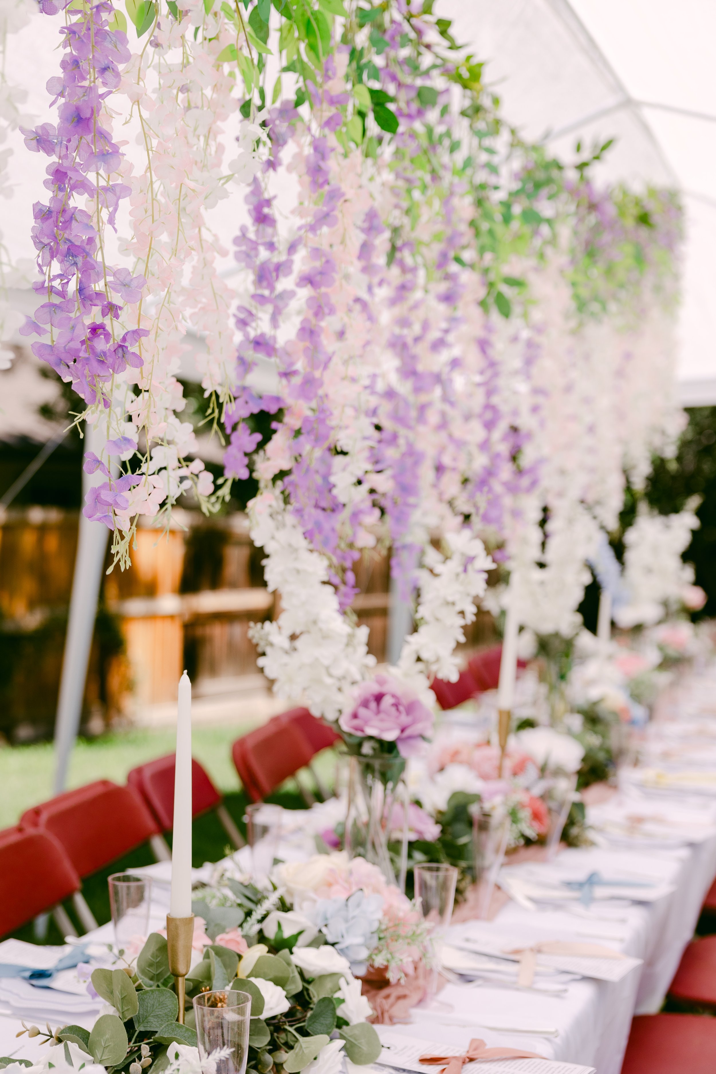 Hanging white florals lining a Colorado wedding reception aisle