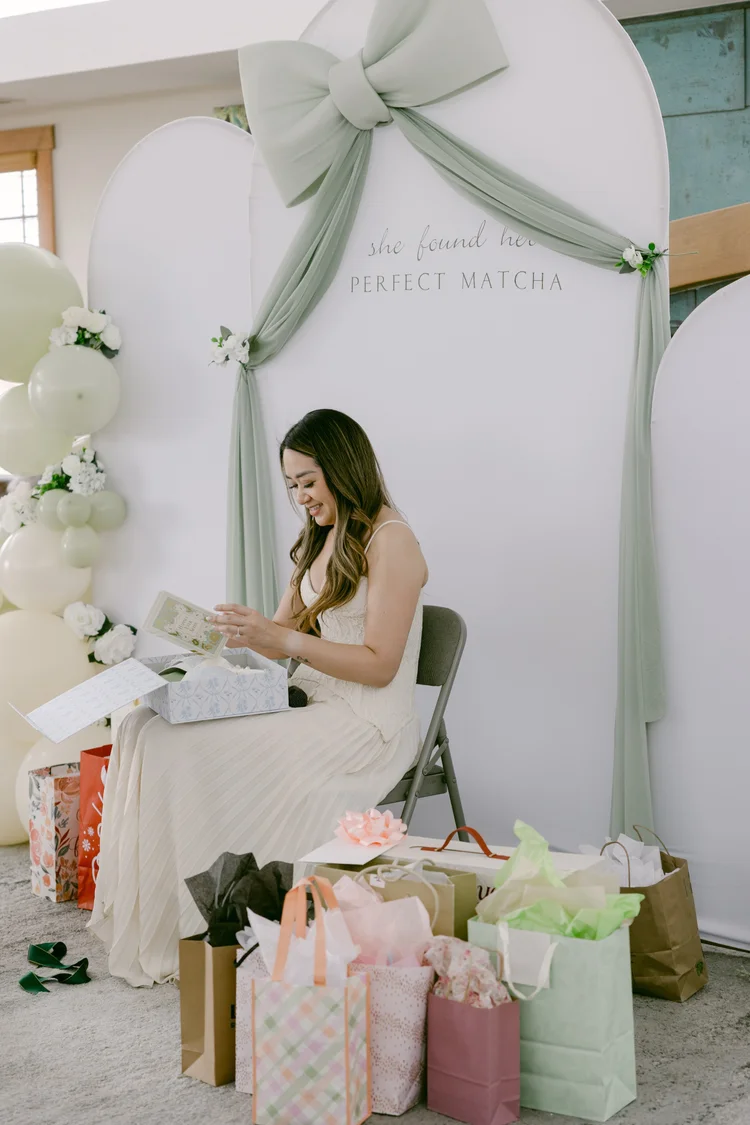 Shower celebration with balloons, drapery, and gift bags
