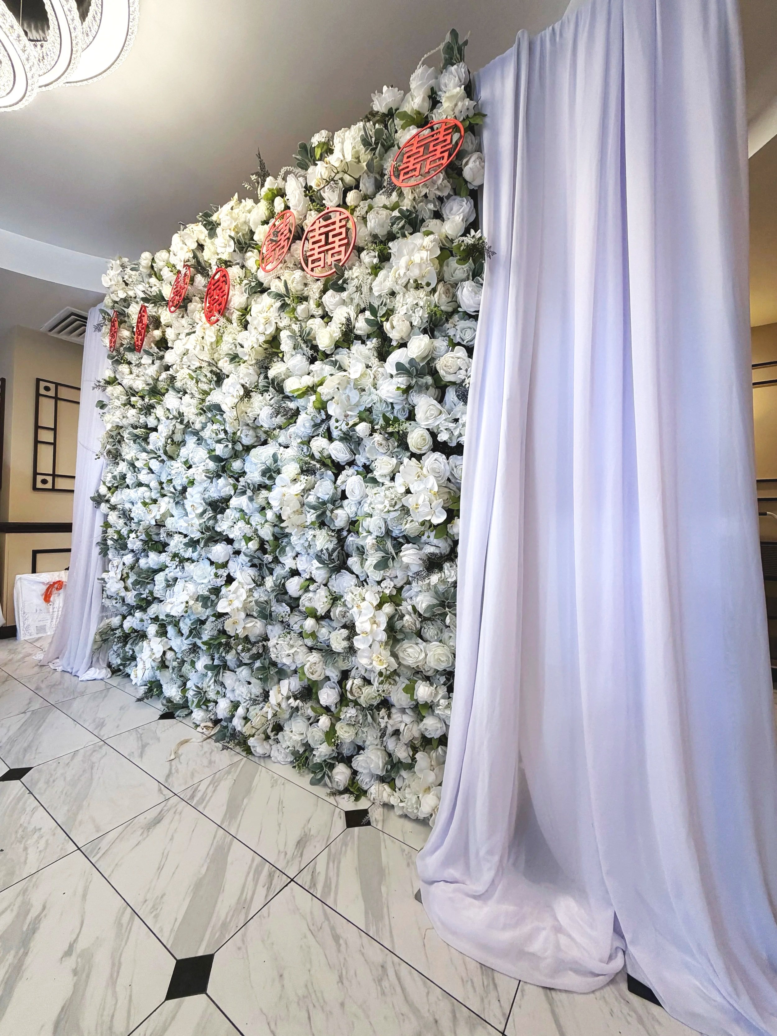White floral wall backdrop with sheer draping rental at a Colorado event