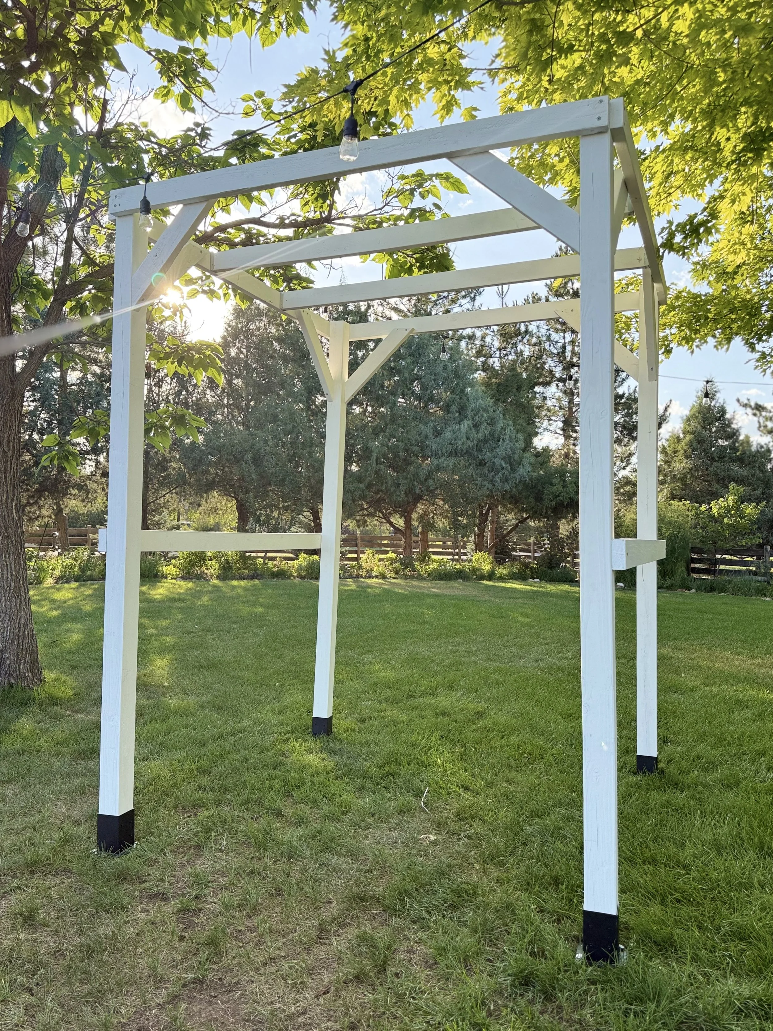 A sturdy, modern ceremony structure ready for custom florals, draping, or greenery.