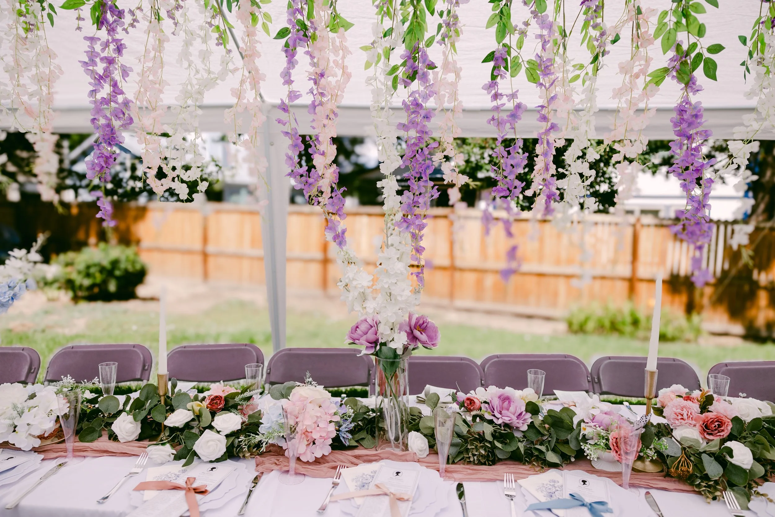 Cascading wisteria over a floral-topped reception table in Colorado
