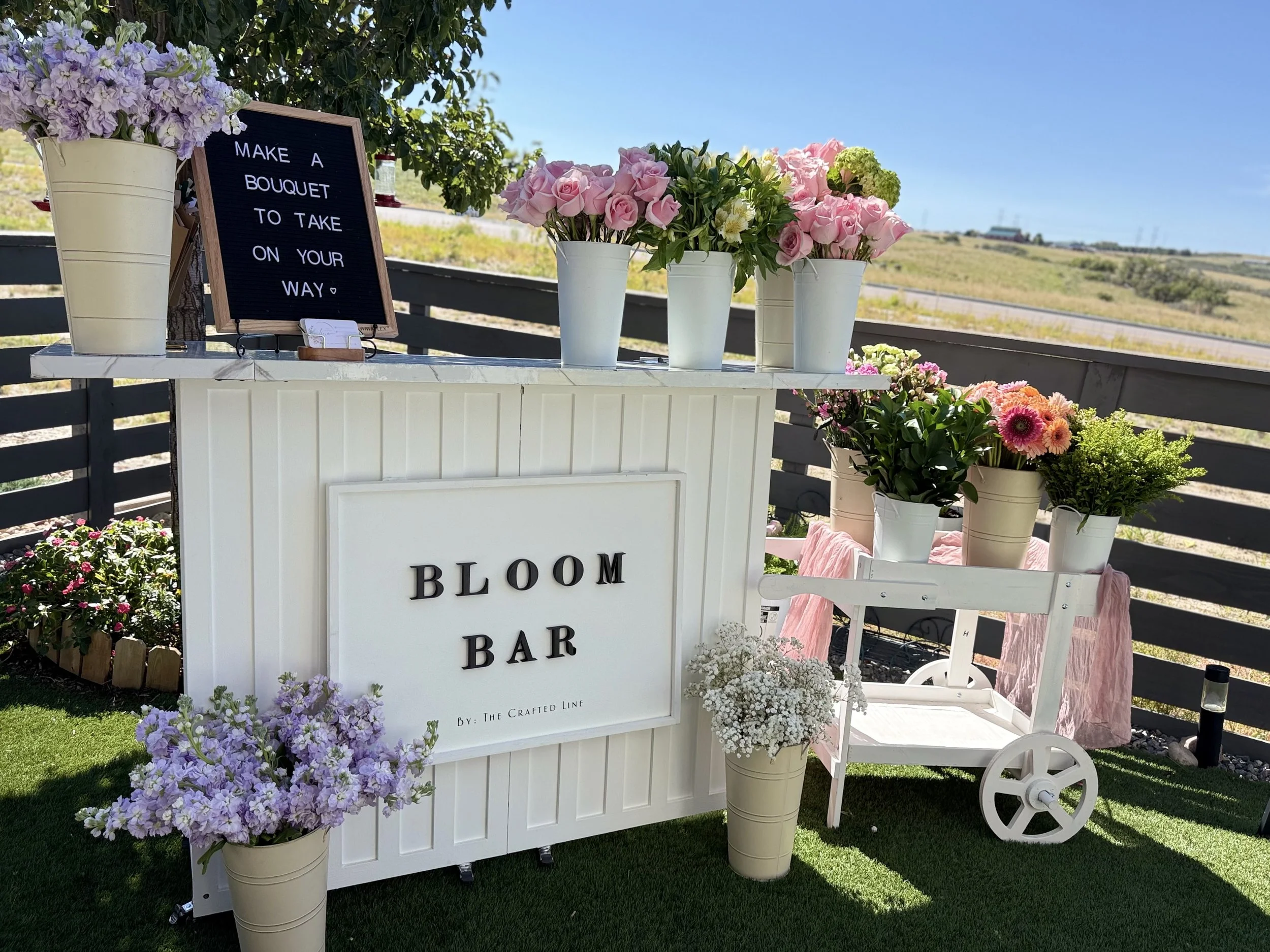 Tiered shelving filled with pastel florals and décor pieces, creating a boutique‑style backdrop for bloom bars or event rentals. Ideal for adding height, texture, and charm to any space.