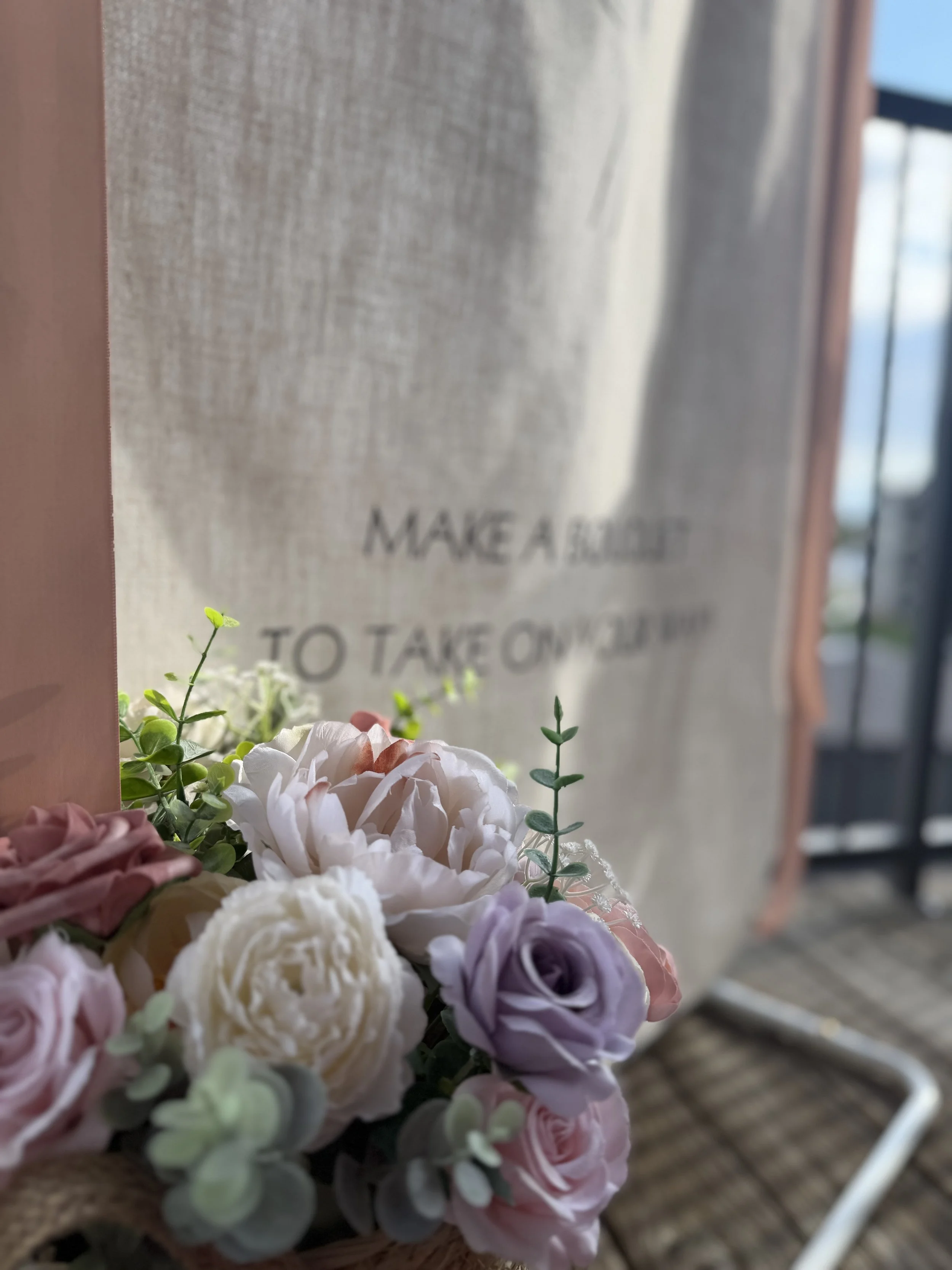 "Make a bouquet to take home" signage beside pastel florals at a Colorado bloom bar