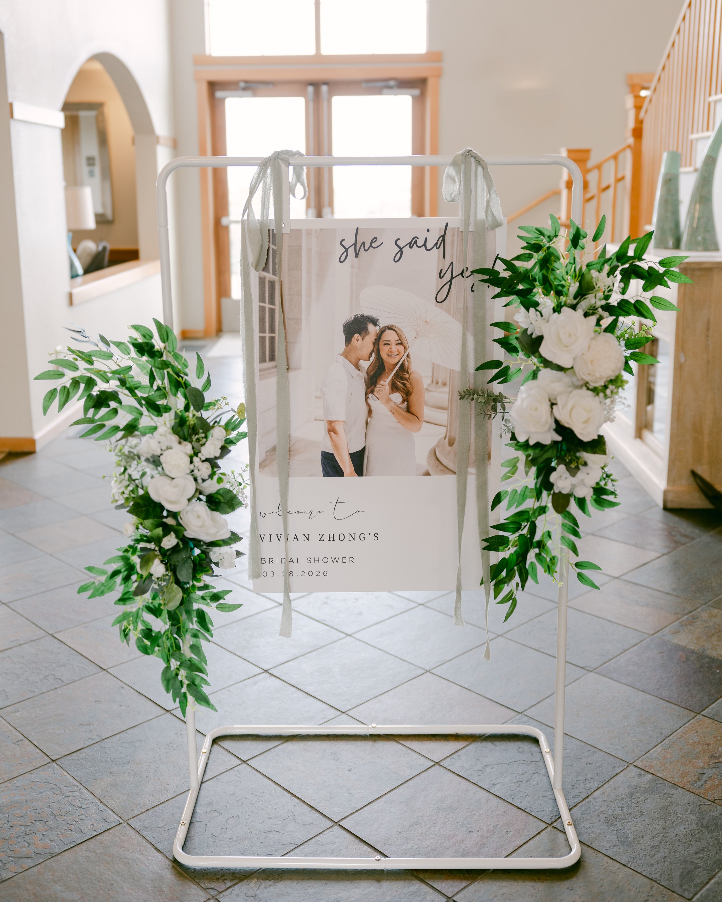 White arch with greenery and a welcome sign for a Colorado wedding