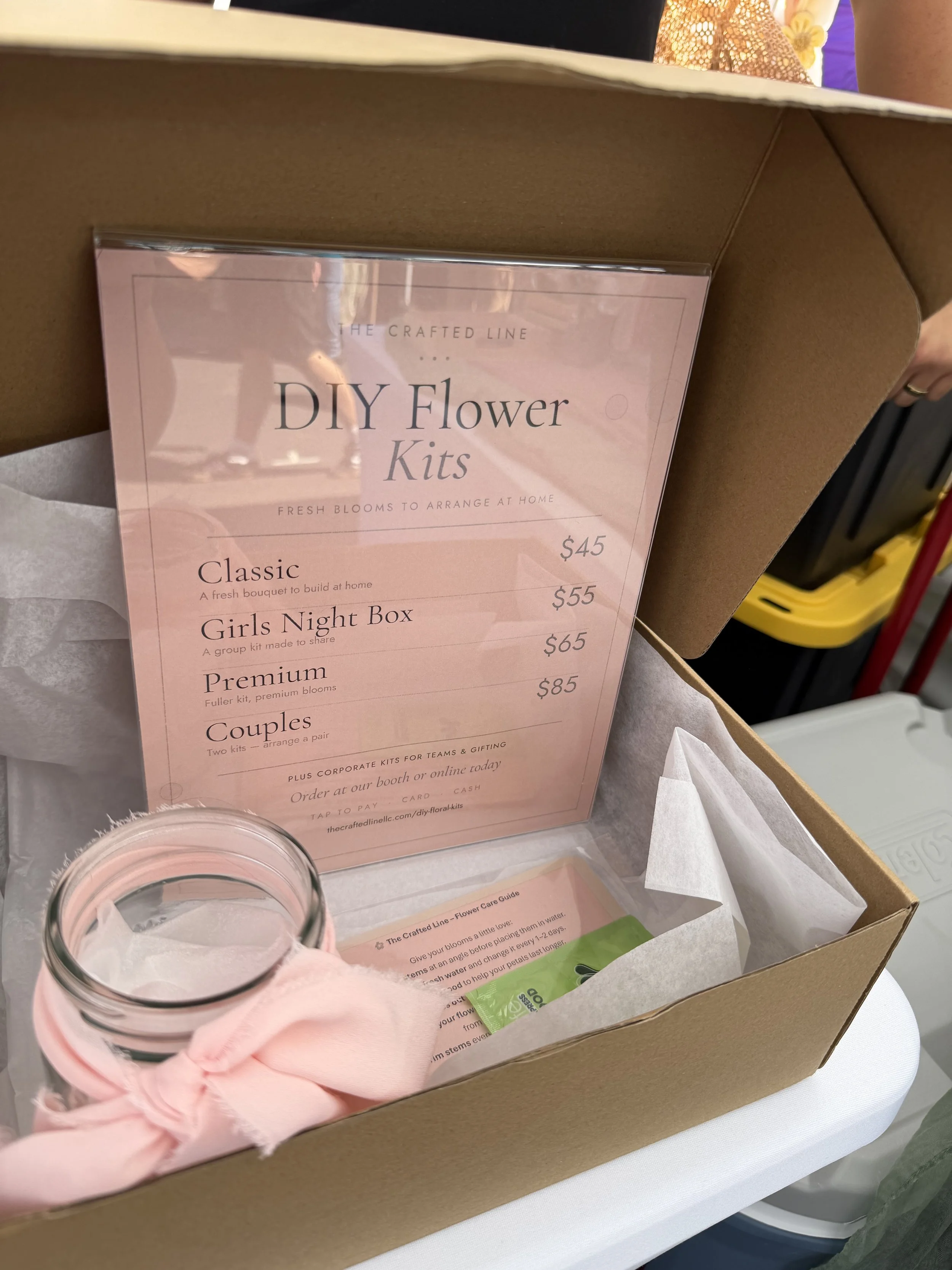 A close‑up of your “DIY Flower Kit” box surrounded by pastel stationery — ideal for highlighting interactive floral products.