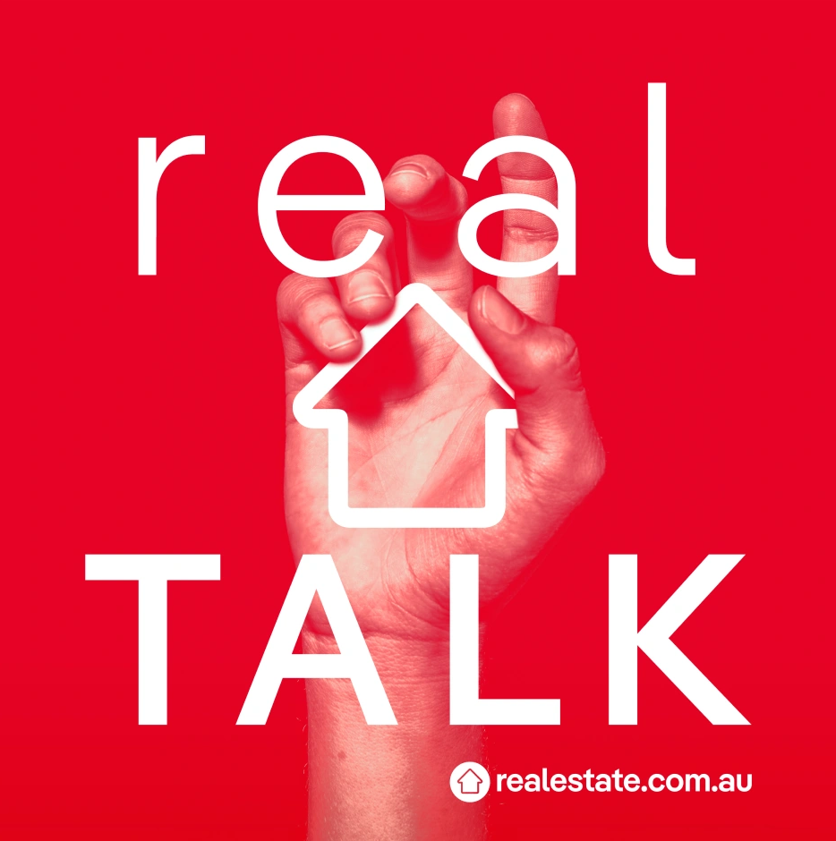 Red background with a hand making a signing gesture. White text reads 'real TALK' with a house icon in place of the letter 'A' and the website 'realestate.com.au' at the bottom.