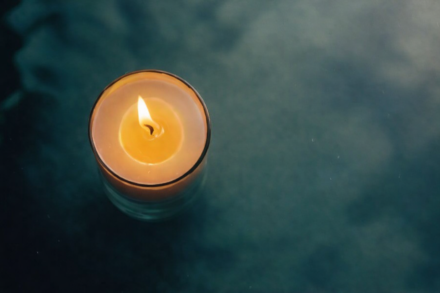 Hand-poured Ignis Knosis candle burning with a steady flame, representing illumination, focus, and personal transformation.
