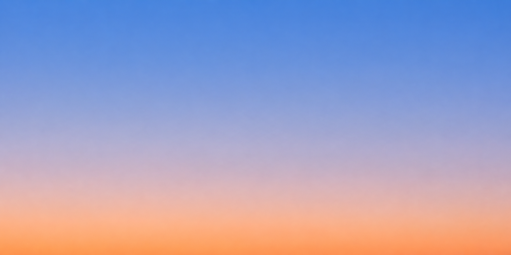 A gradient sky during sunset with hues of orange, pink, purple, and blue.