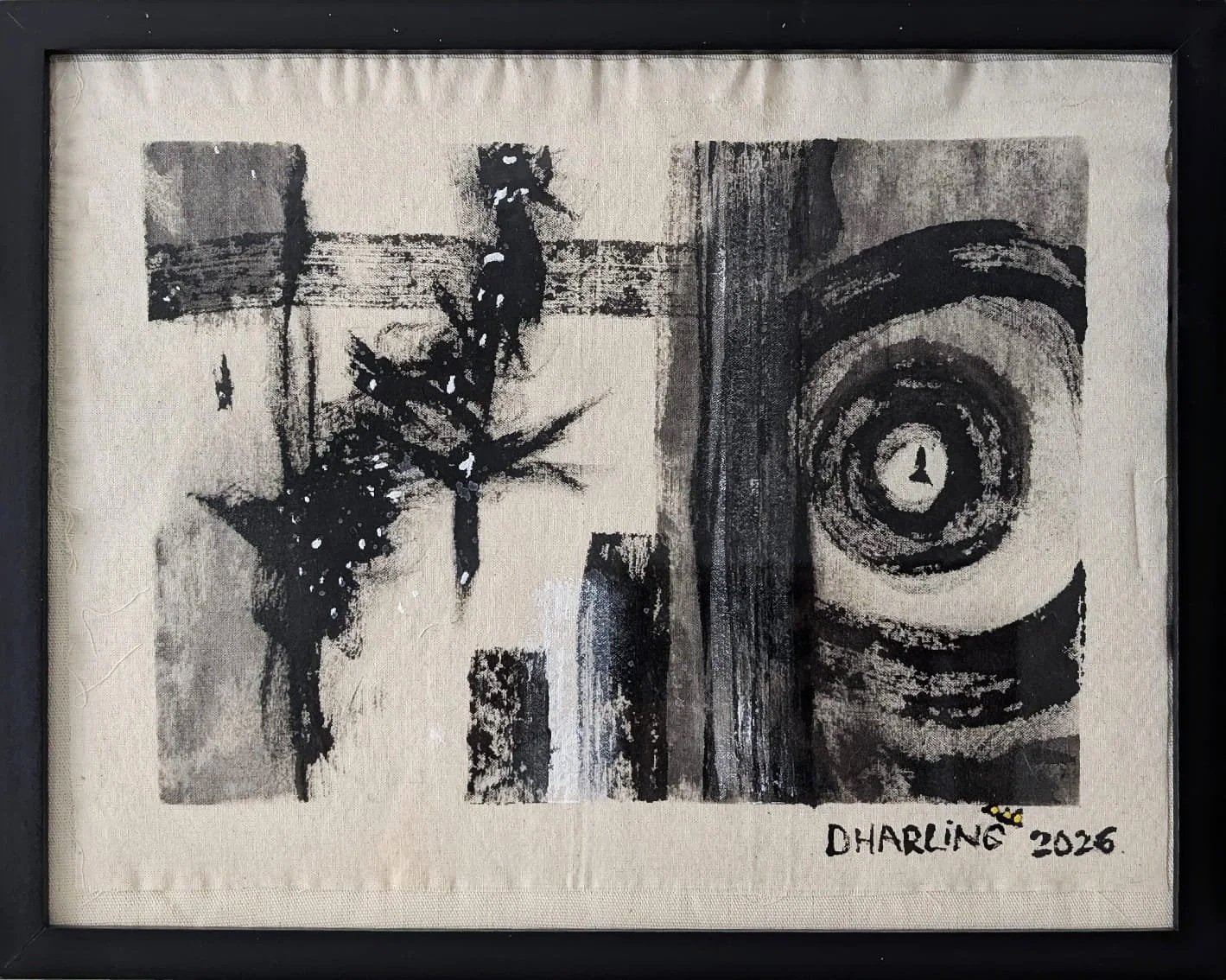 A black and white painting featuring abstract shapes emulating the universe and stars, and circular patterns, signed by artist Dharma 'Dharling 2026' in the bottom right corner, framed in black.