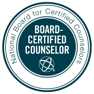 A circular emblem with a teal border and white background, saying "National Board for Certified Counselors" around the edge, and in the center "Board-Certified Counselor" with a small globe icon underneath.
