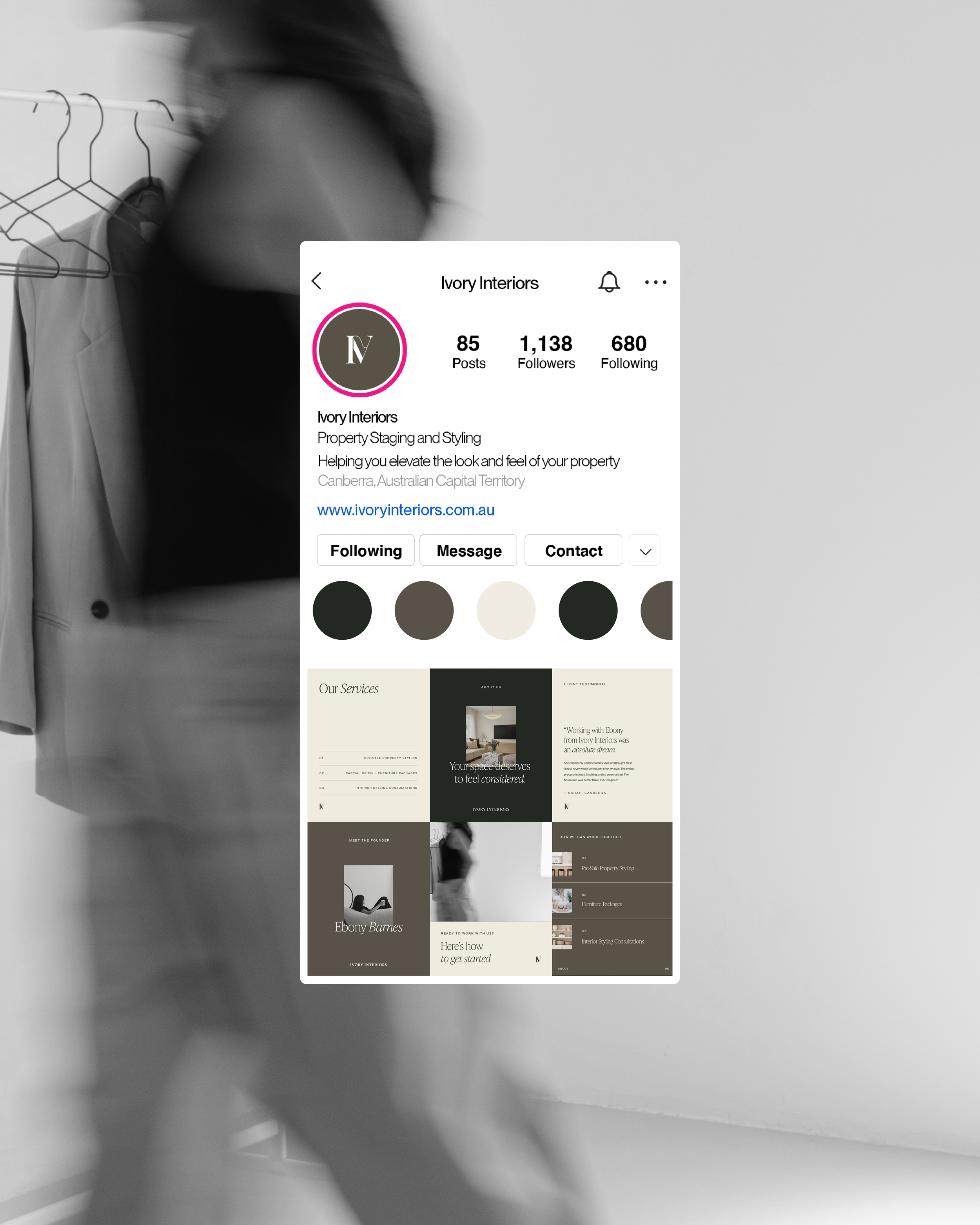 Blurred image of a person walking past a display screen showcasing a business profile for Ivory Interiors, including their logo, contact options, and sample content.