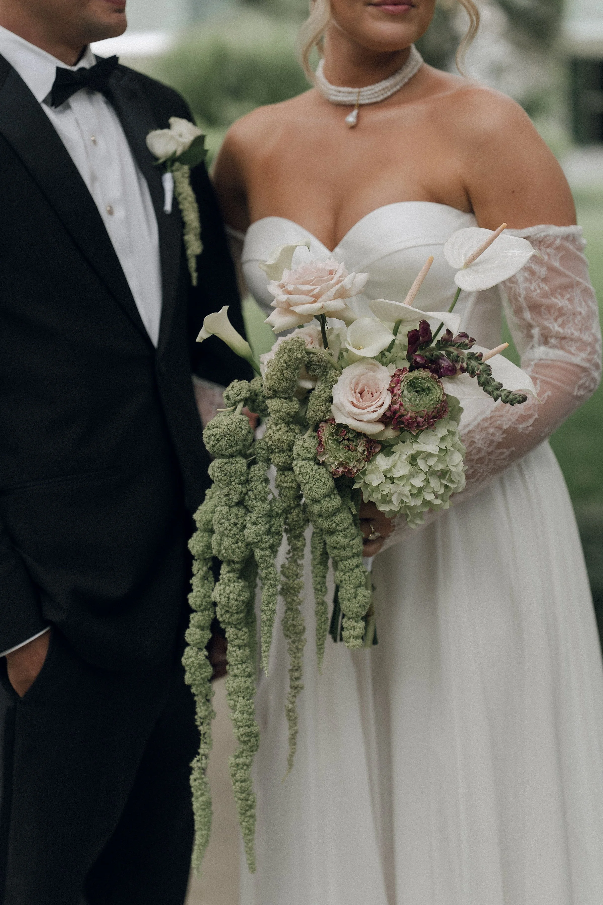 Elevated, modern and elegant bridal bouquet with soft tones and hanging amaranthus.