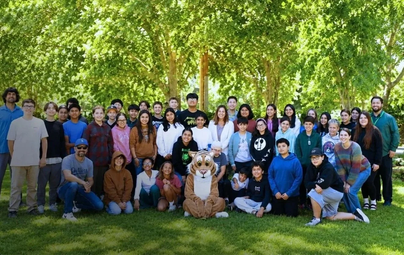 Group photo of the entire College School District community with the Bobcat mascot.