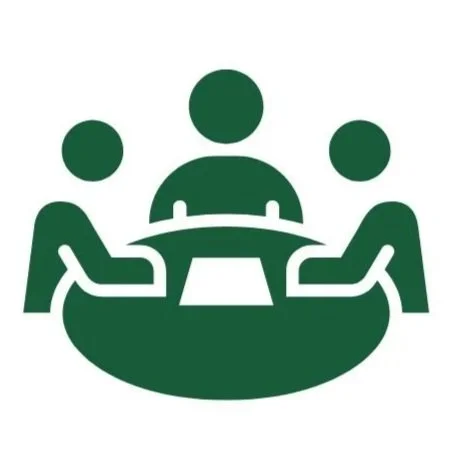 Icon of three people sitting around a round table, representing a meeting or discussion.