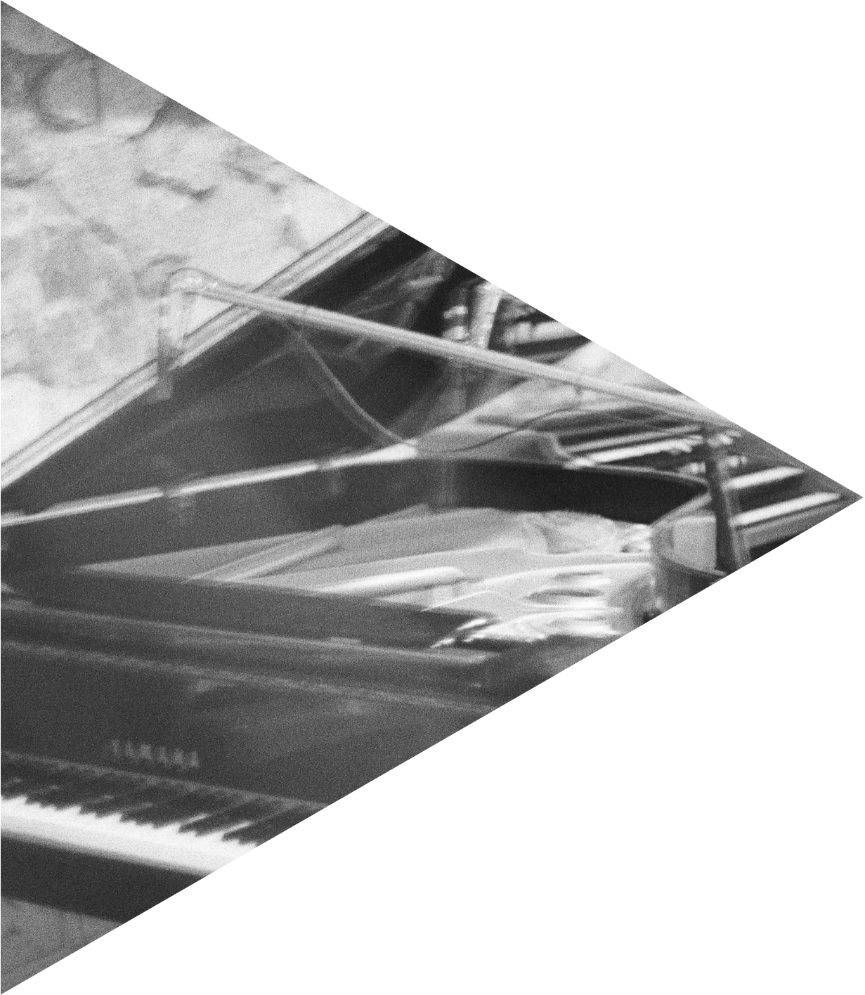 A piano with a microphone placed on top of it, situated next to a window with curtains.
