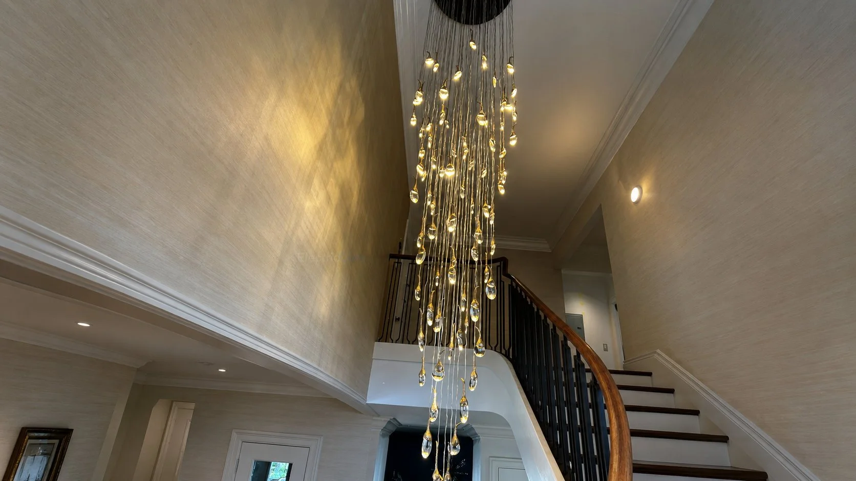 Staircase chandelier installation with wall accent lighting, recessed lights, and integrated residential electrical work by Electric Core in SF Bay Area