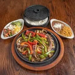 Grilled chicken thigh, fried plantain, mixed salad with lettuce and tomato, served with rice.