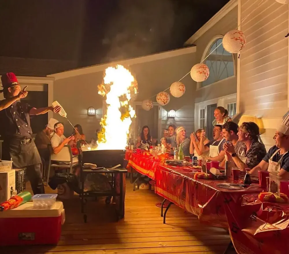 Exciting Backyard Hibachi cooking experience with a live chef flame show, creating an unforgettable atmosphere for any Baby Shower or private event.