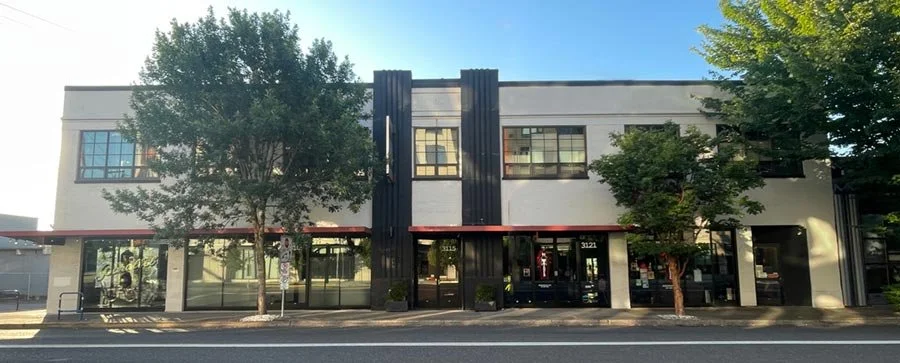 A photo of the Bindery Building, home of the Nourishing Life Collective whole health clinic and community hub, located at 3115 NE Sandy Blvd, Suite 231, in Portland, Oregon.