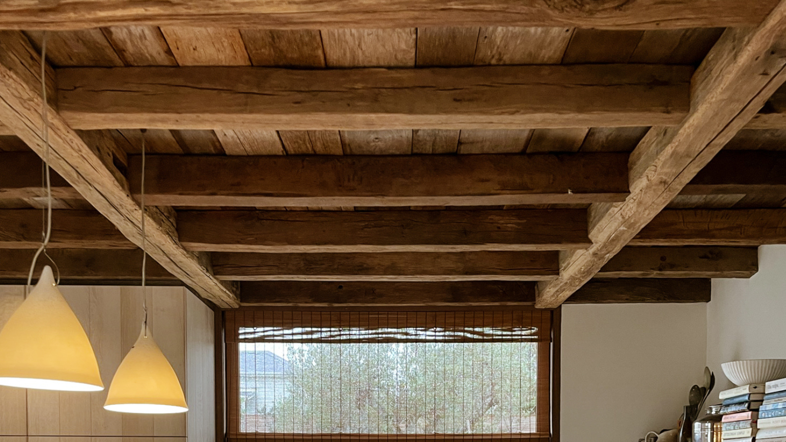 Reclaimed oak ceiling beams in an antique oak kitchen, showing aged European timber, natural patina and warm character.