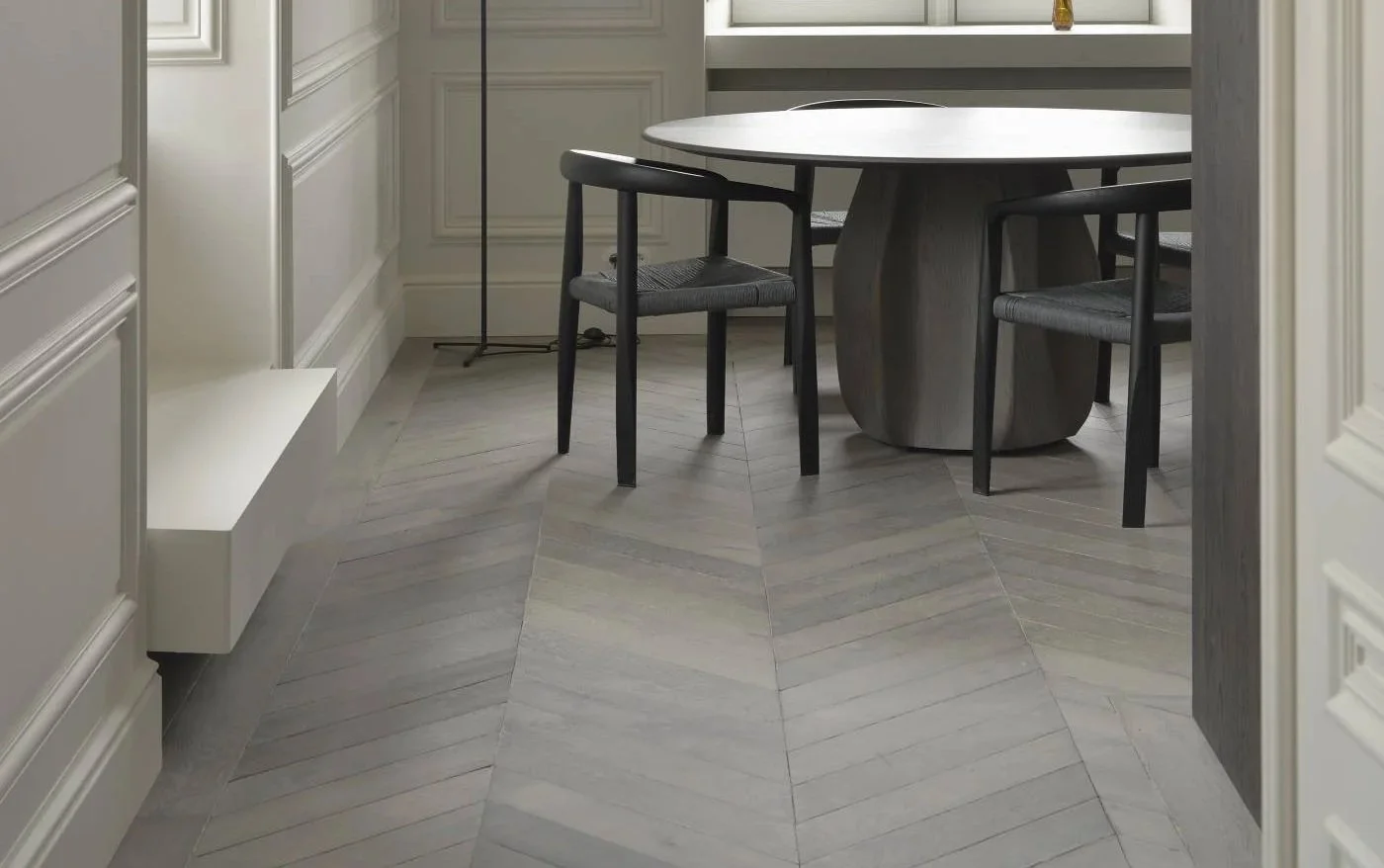 Light grey oak chevron flooring in a contemporary kitchen and dining area, creating a clean and refined interior finish.