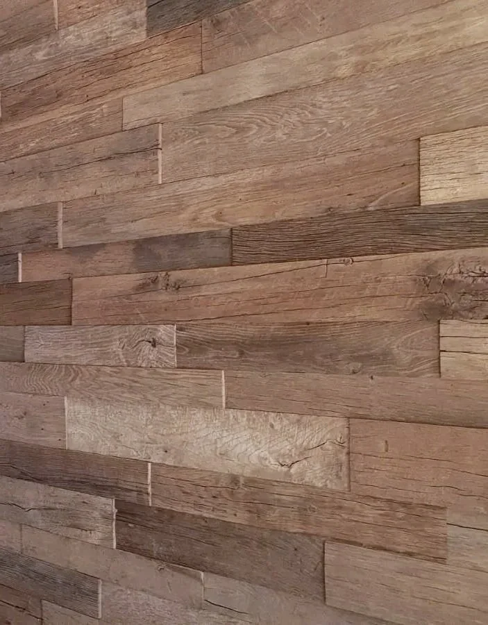 Reclaimed oak wall panels used as interior wall lining, showing natural grain, tonal variation, aged surface texture and rustic timber character.