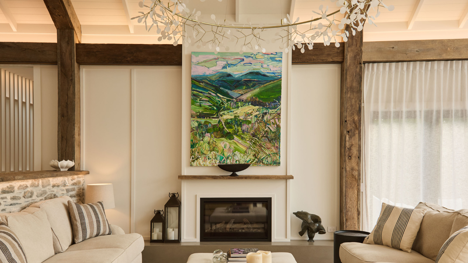 Reclaimed oak box beams and beam facings used around a fireplace in a warm living room interior.