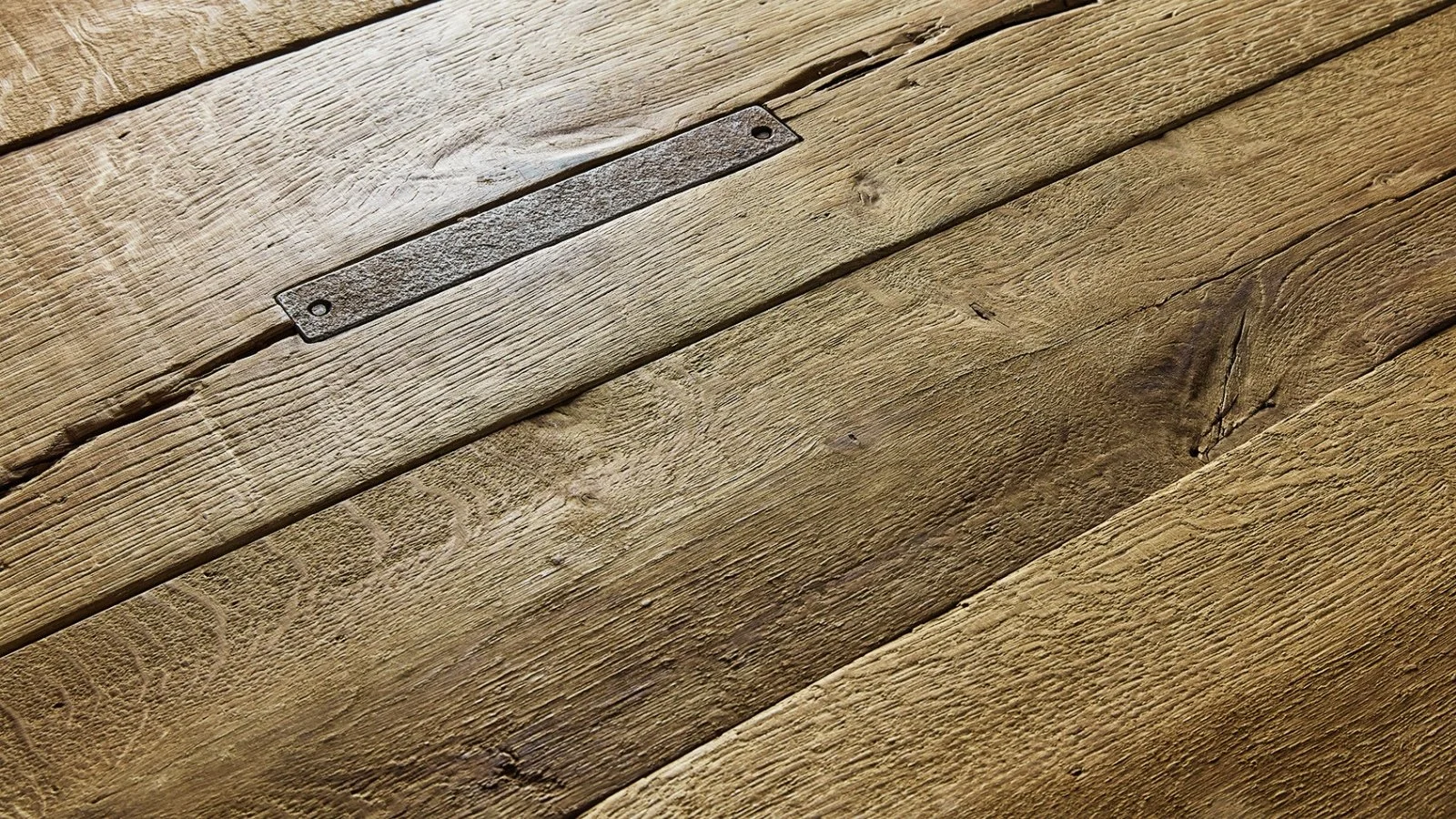 Reclaimed European oak flooring showing aged grain, rustic surface texture and natural character detail.