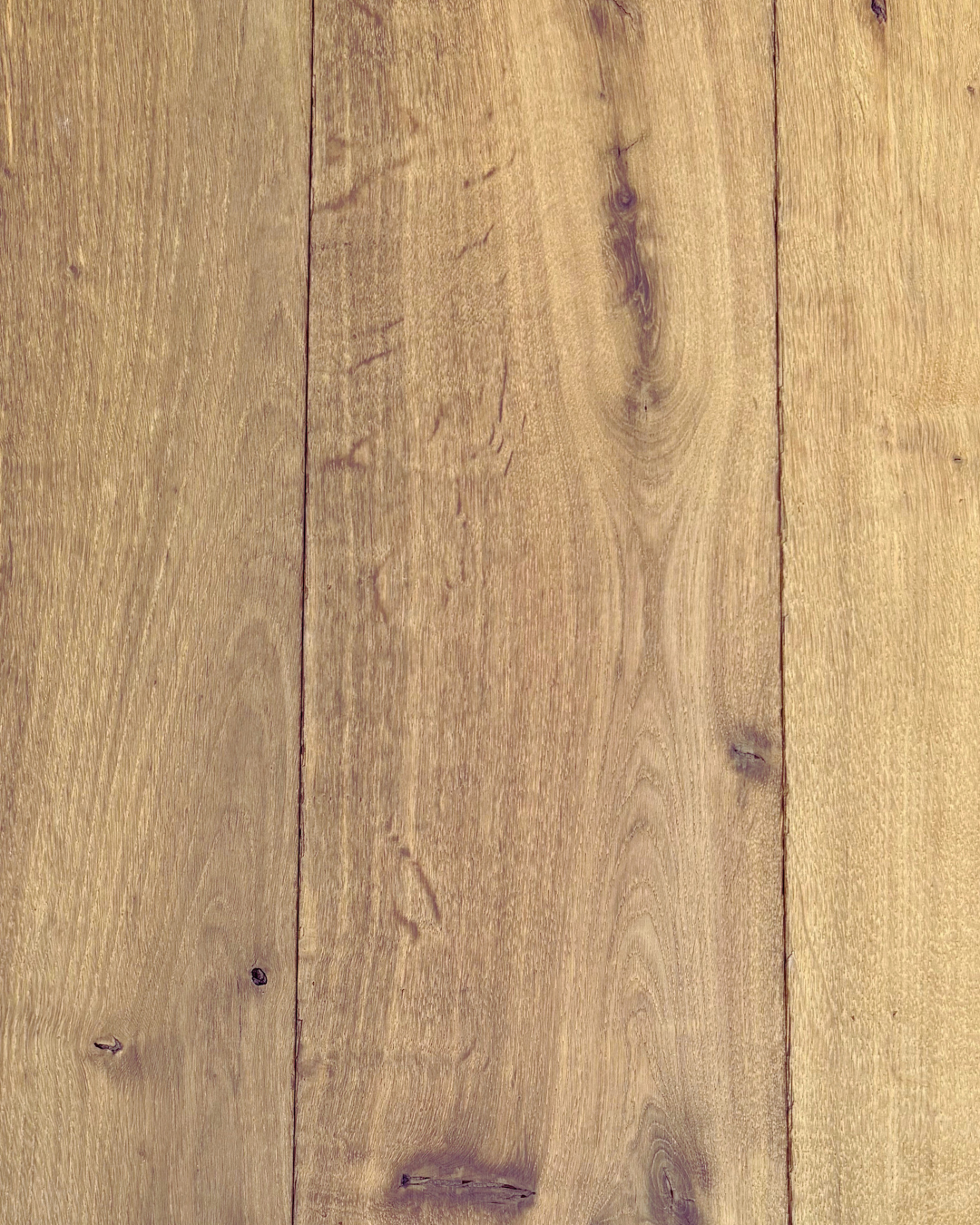 Dressed reclaimed oak boards with a smoother surface, visible grain and natural tonal variation.