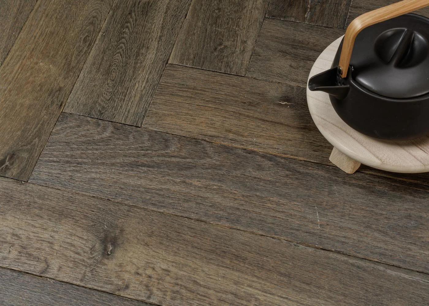 Close-up of grey-toned oak flooring with visible grain, texture and subtle aged character.