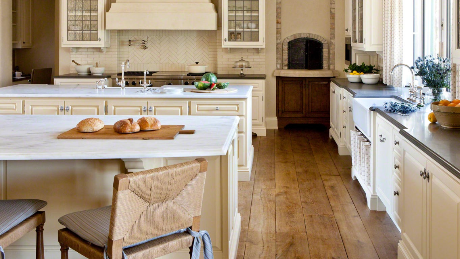 Vintage French oak flooring brings warmth, softness and natural character to this light, country-style kitchen.