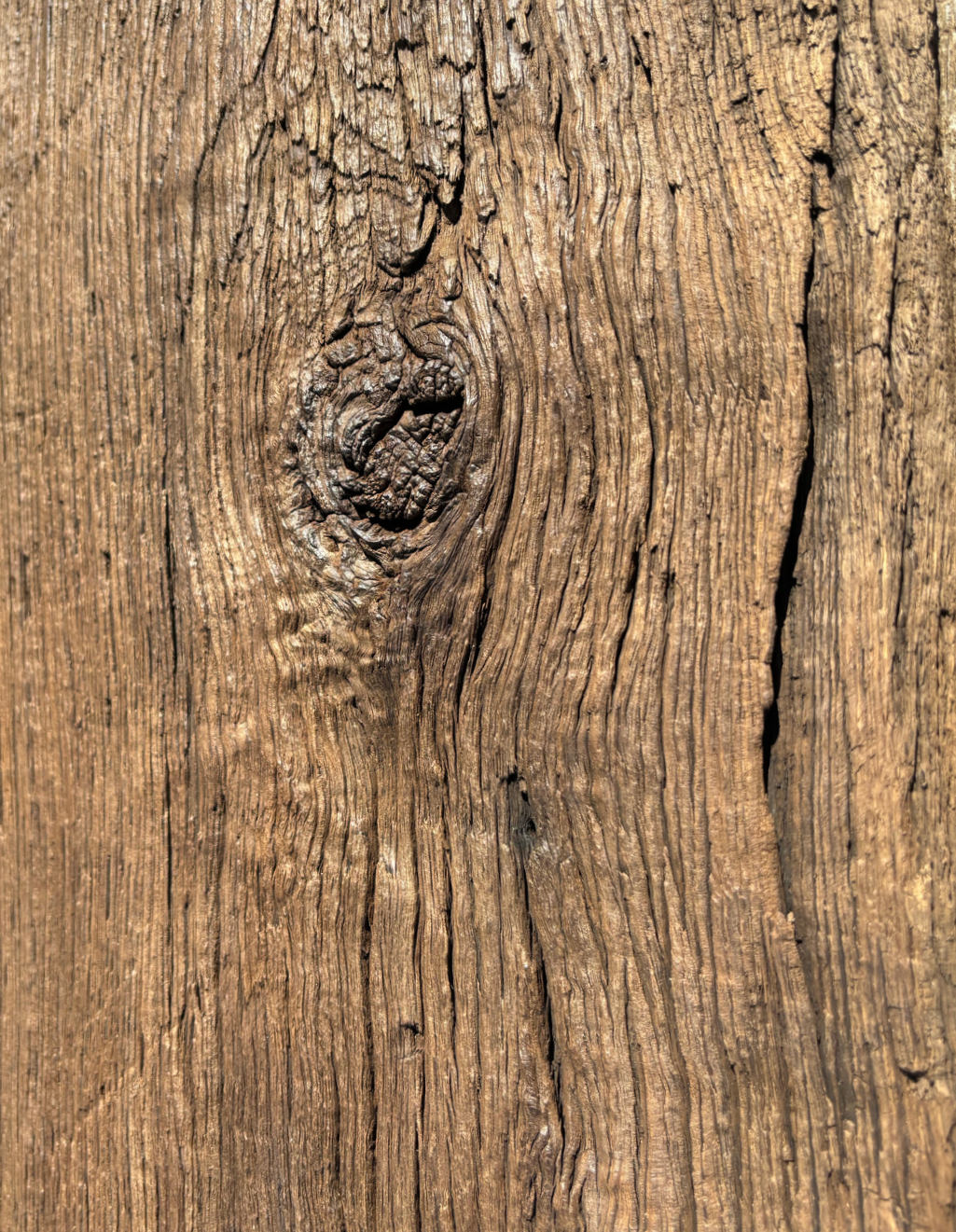 Close-up detail of reclaimed European oak showing aged grain, natural knots, cracks and weathered surface texture. These features give box beams and beam facings their authentic antique oak character.