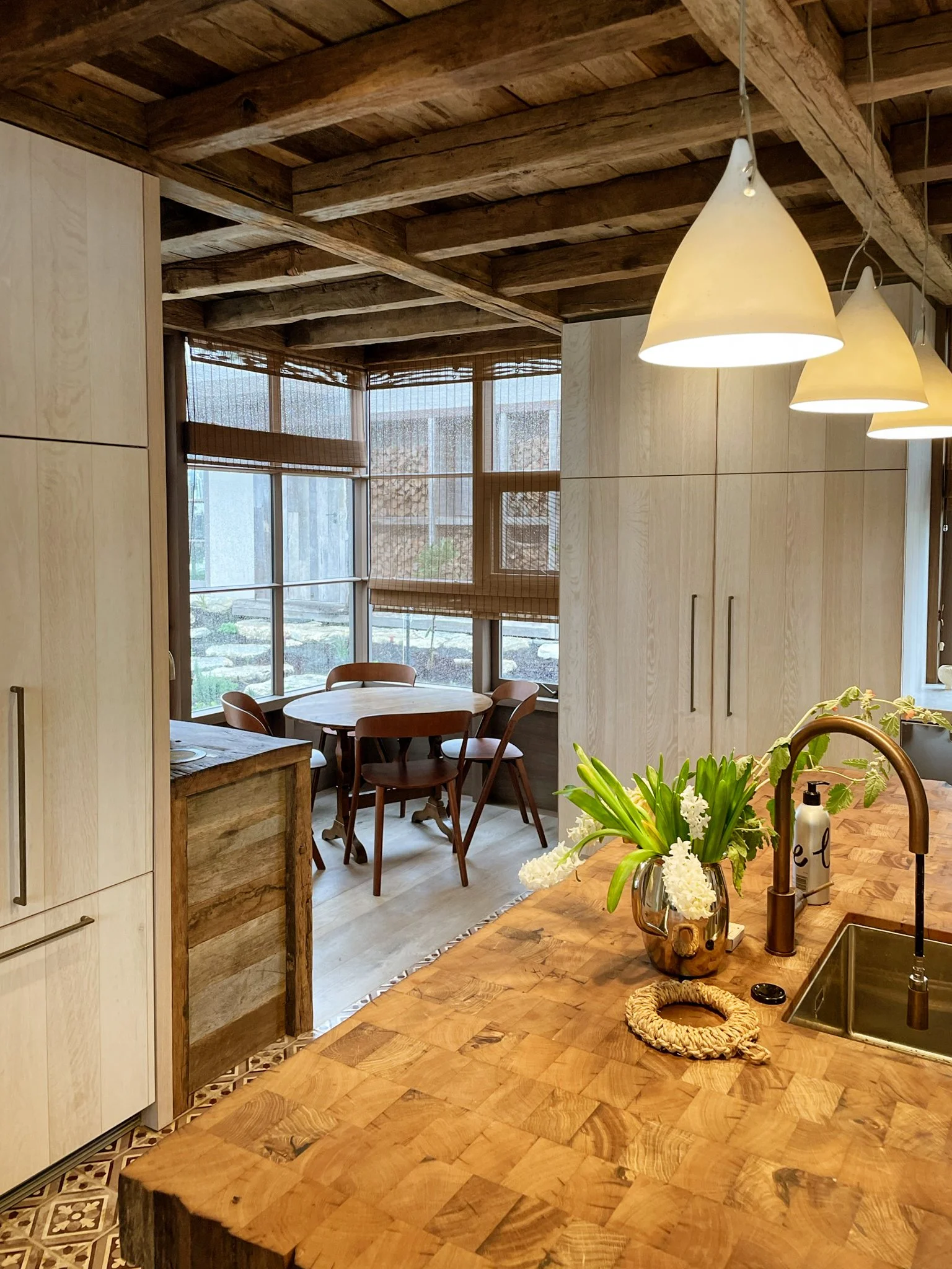 End grain butchers block, and a rustic wooden ceiling.