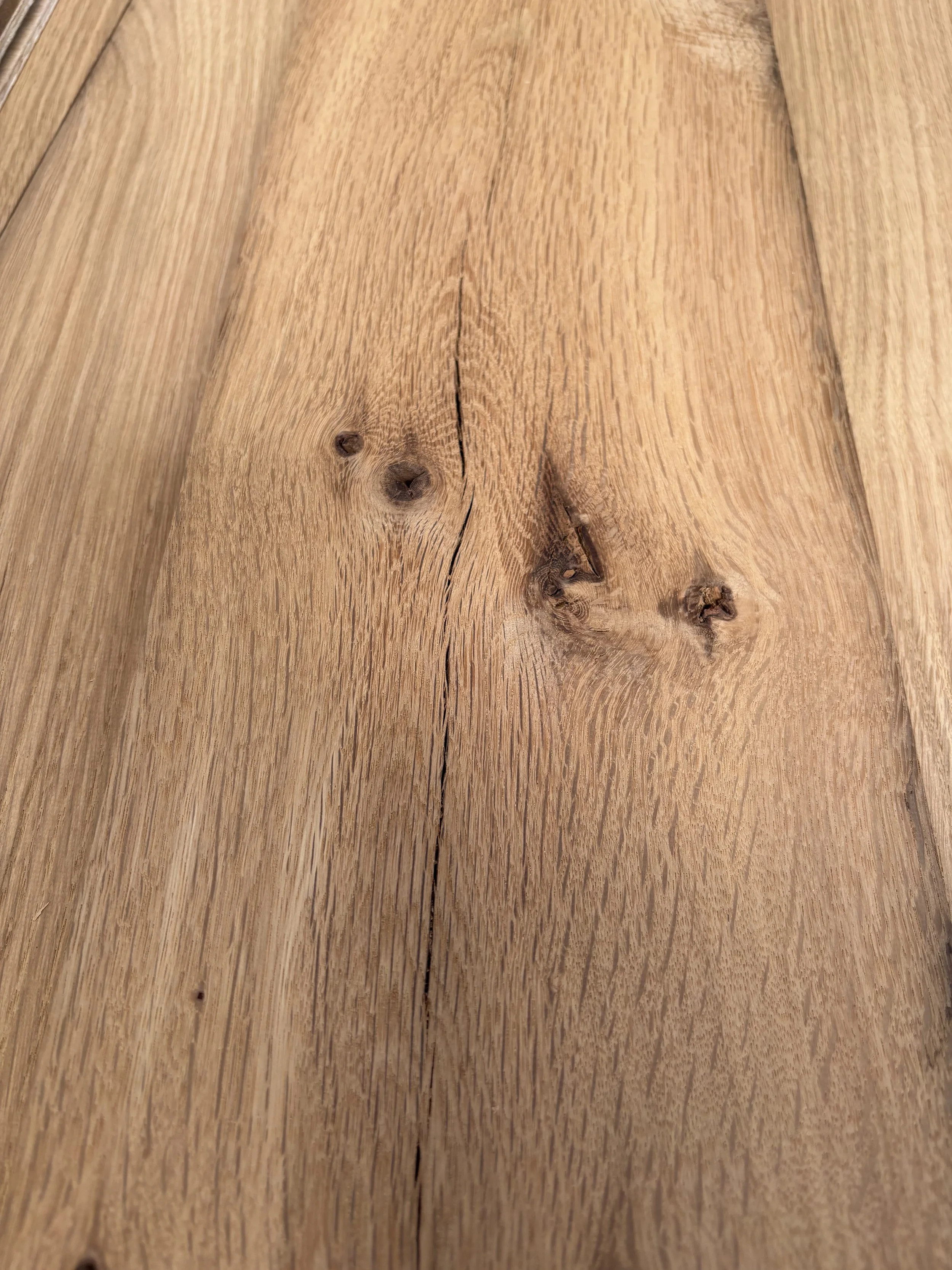 Close-up of a wooden surface with visible grain and knots.