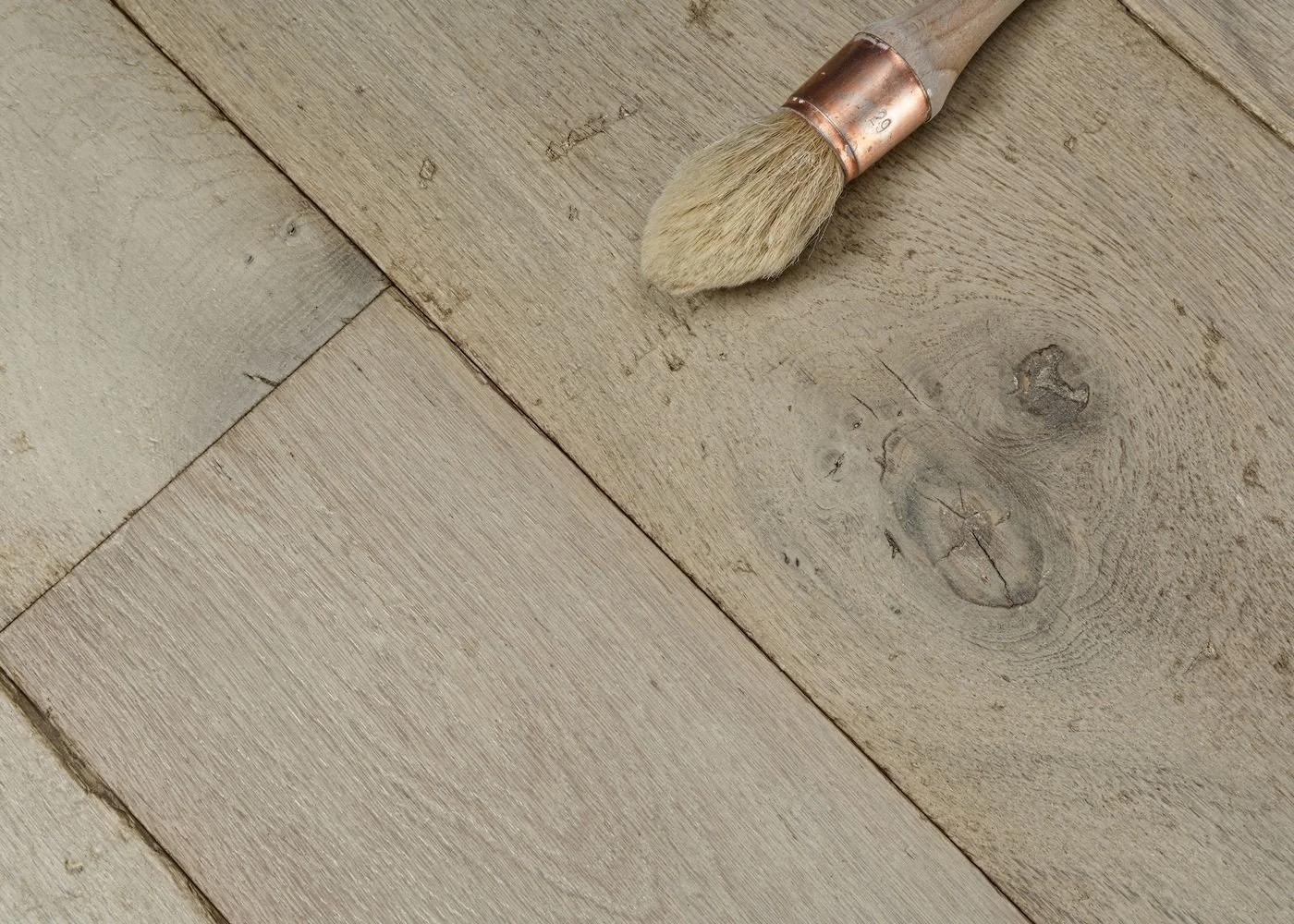 light-colored wooden floor, with visible wood grains and knots.