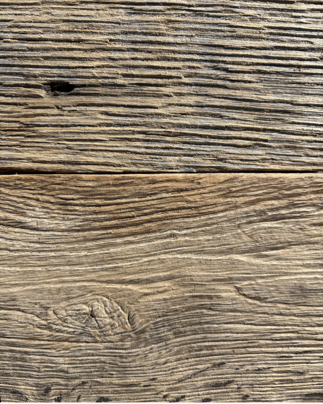 Close-up of weathered wooden planks with visible grain and knots.