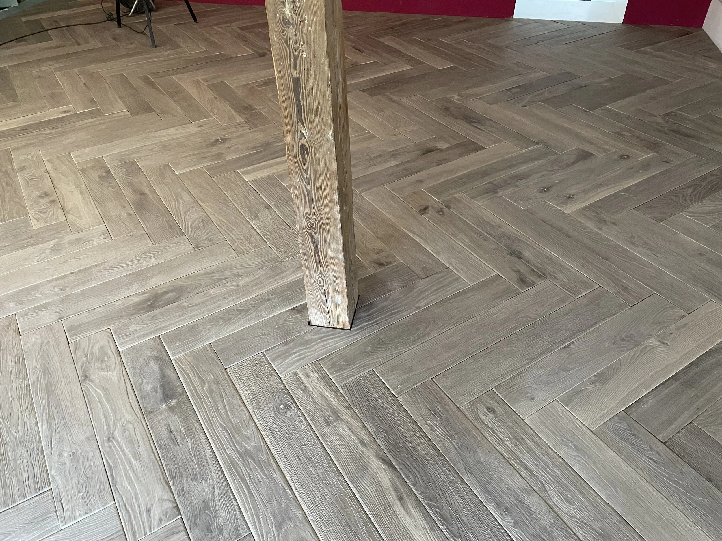 Antique oak herringbone flooring with natural grain and aged texture