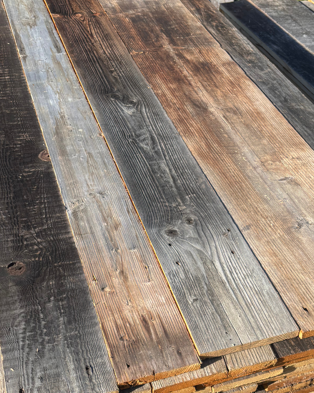 Reclaimed Baltic pine barn wood boards with aged grey and brown weathered surfaces