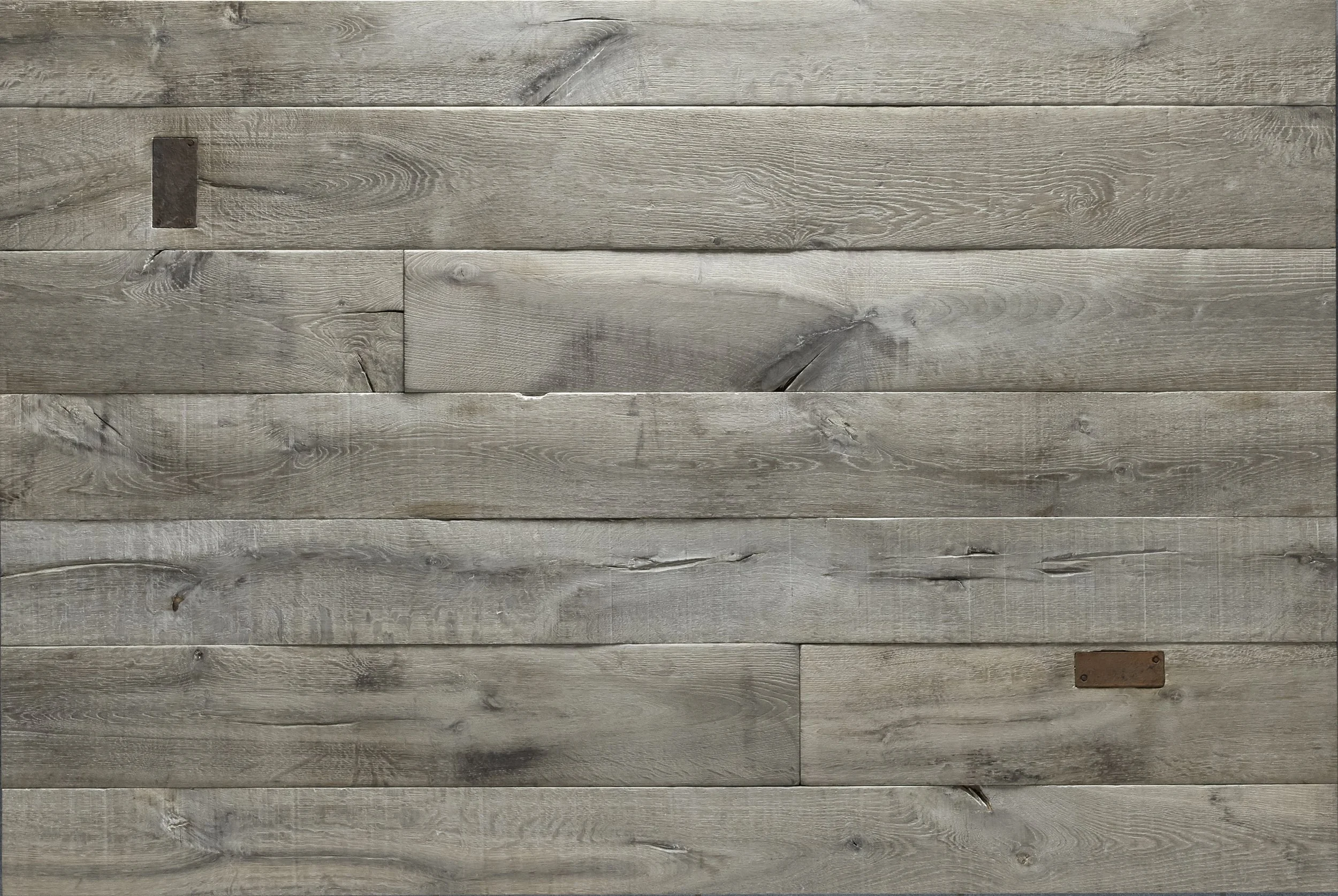 A wooden wall made of horizontal planks in a weathered, grayish tone with rustic metal accents.