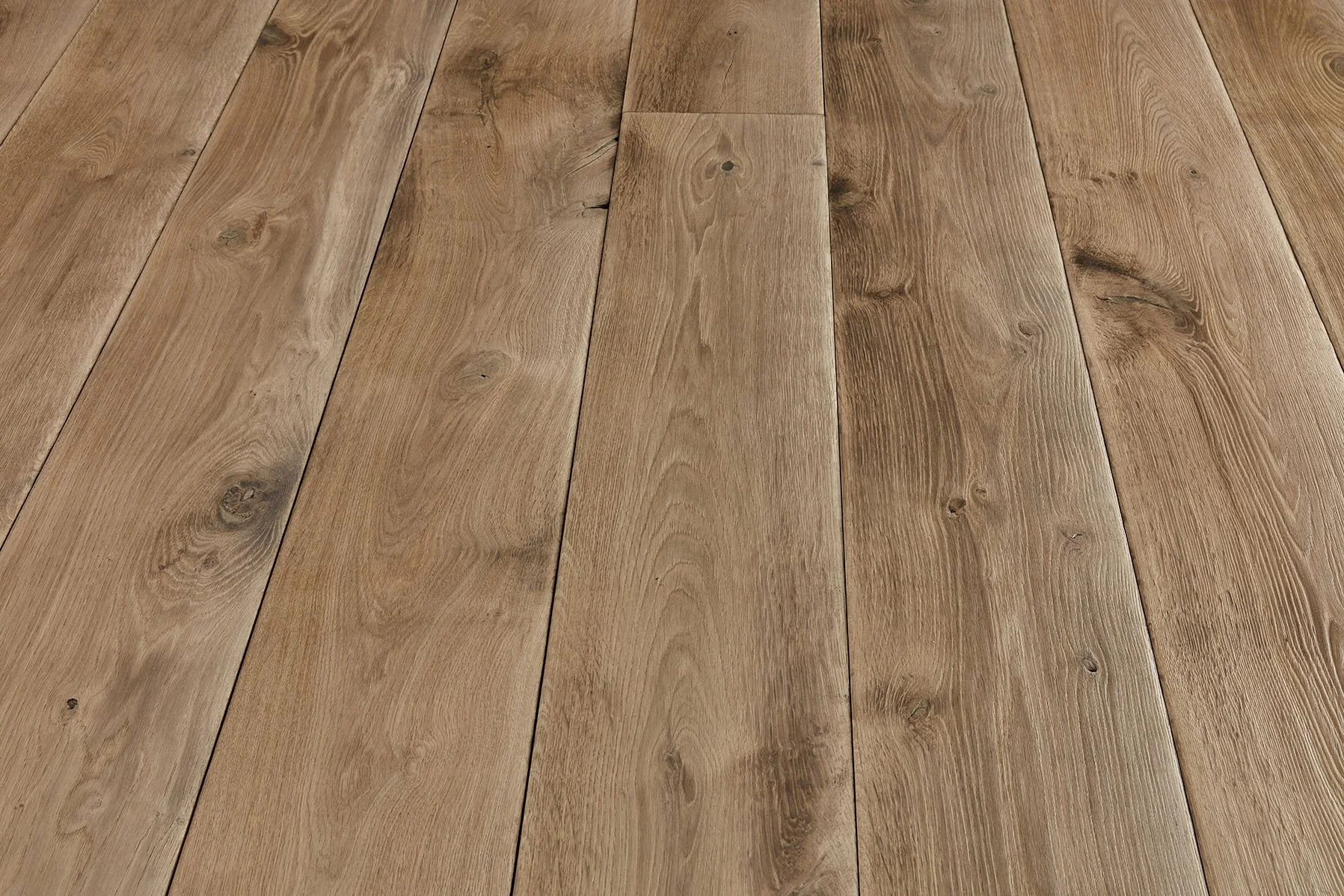 Close-up of a wooden floor with visible wood grain and knots.