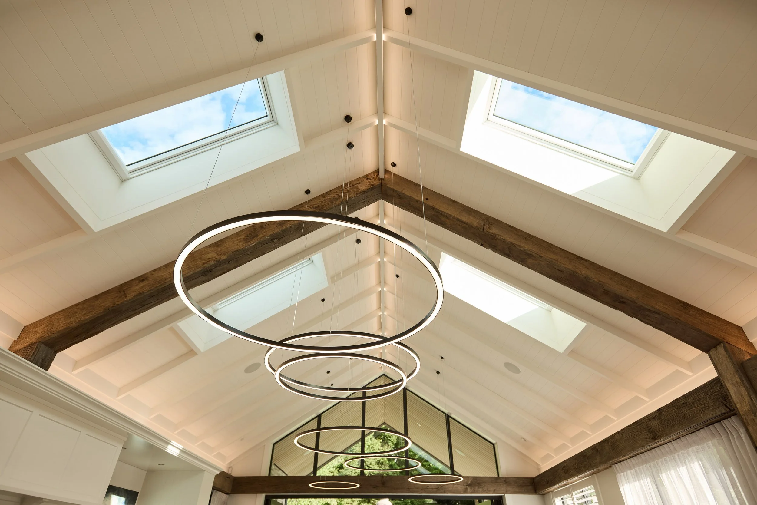 Interior ceiling with large skylights, and wooden beams made of rustic oak. country modern 