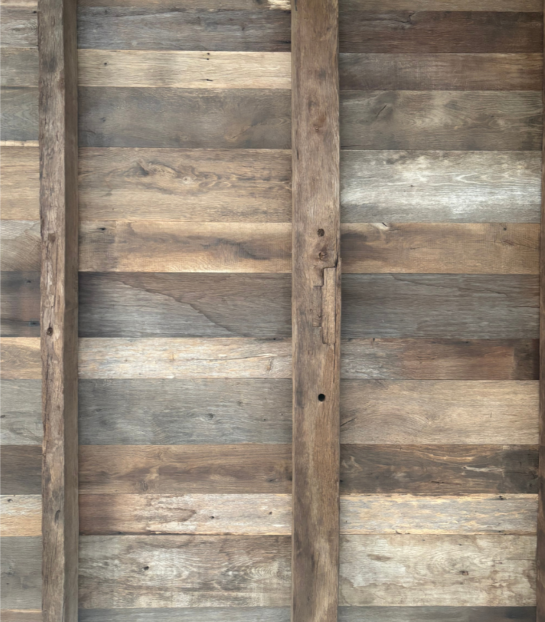Reclaimed European oak boards used as interior wall lining with natural weathering, mixed tones and aged surface character.