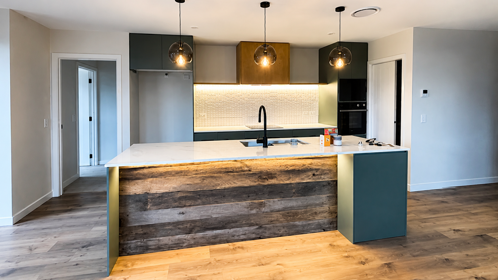 Modern kitchen featuring a reclaimed European oak island front with aged timber texture and natural character.