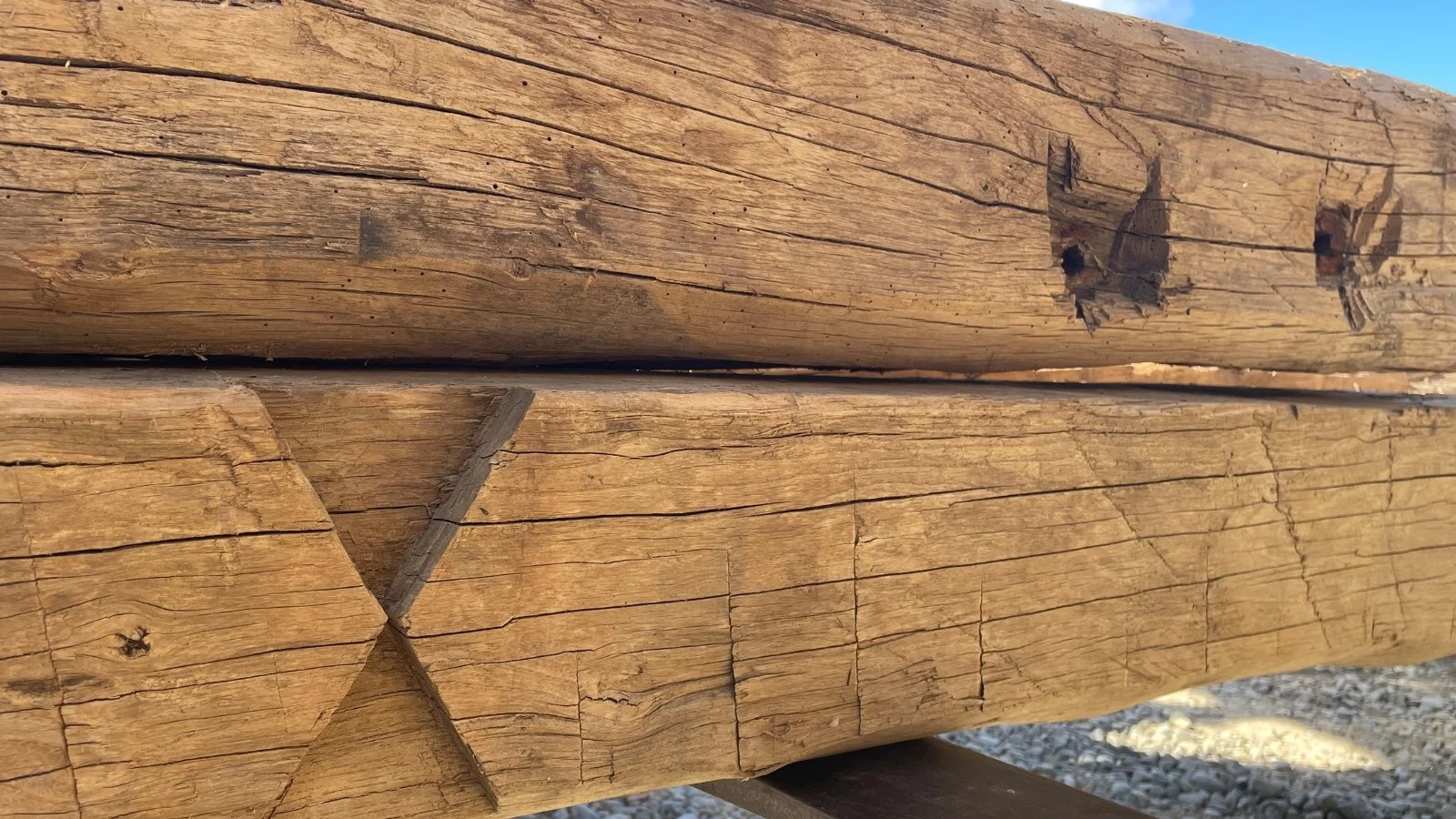 Reclaimed European oak beams with aged grain, historic cracks and natural surface character.