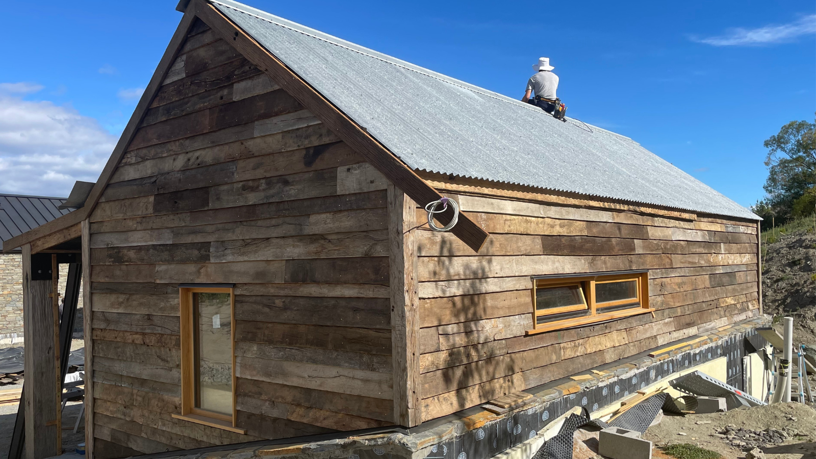 Reclaimed oak cladding boards used on the exterior of a New Zealand home, showing natural weathered texture and aged timber character.